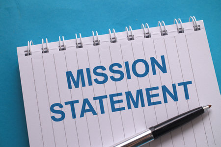 Mission statement, text words typography written on book against blue background, life and business motivational inspirational conceptの写真素材