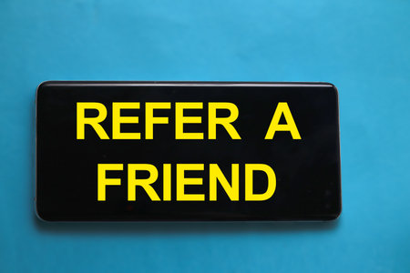 Refer a friend, text words typography written on smart phone, life and business motivational inspirational conceptの写真素材