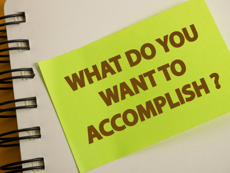 What do you want to accomplish, text words typography written on paper against wooden background, life and business motivational inspirational conceptの写真素材