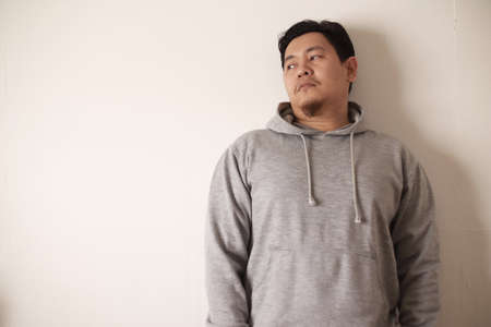 Sad depressed anxiety Asian man thinking contemplating bad thing happened in his life, stress exhausted feeling down expression, financial or relationship problem conceptの写真素材