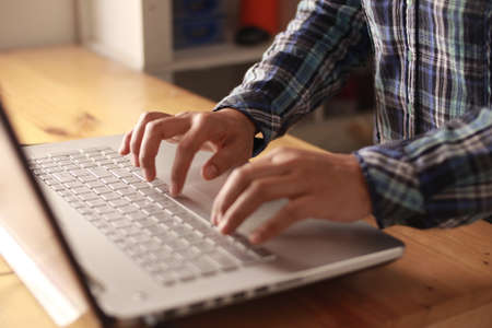 Close up of person fingers typing on laptop, business or education concept