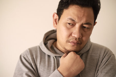 Sad depressed anxiety Asian man thinking contemplating bad thing happened in his life, stress exhausted feeling down expression, financial or relationship problem conceptの写真素材