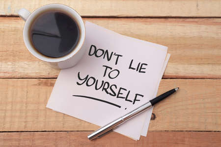 Dont lie to yourself, text words typography written on paper against wooden background, life and business motivational inspirational conceptの写真素材