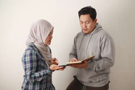 Asian young muslim couple checking analyzing their family financial management report, young family housband and wife confused to have bad financialの写真素材