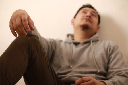 Sad depressed anxiety Asian man thinking contemplating bad thing happened in his life, stress exhausted feeling down expression, financial or relationship problem conceptの写真素材