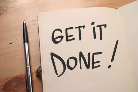 Get it done, text words typography written on book against wooden background, life and business motivational inspirational conceptの写真素材