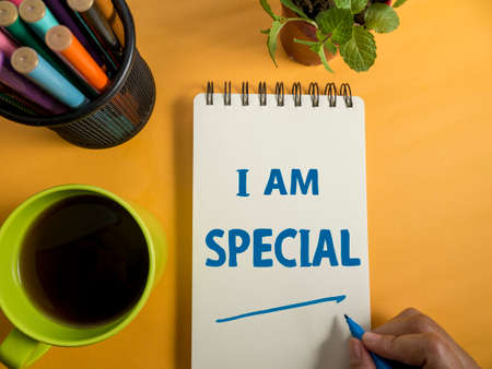 I am special, text words typography written on book against yellow background, life and business motivational inspirational conceptの写真素材