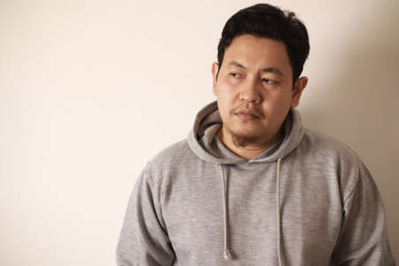 Sad depressed anxiety Asian man thinking contemplating bad thing happened in his life, stress exhausted feeling down expression, financial or relationship problem conceptの写真素材