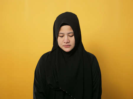 Sad depressed anxiety Asian muslim woman thinking contemplating bad thing happened in her life, stress exhausted feeling down expression, financial or relationship problem conceptの写真素材