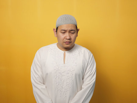 Sad depressed anxiety Asian musilm man thinking contemplating bad thing happened in his life, stress exhausted feeling down expression, financial or relationship problem conceptの写真素材