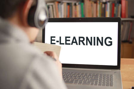 Anonymous person typing on laptop with e learning digital web program displayed on screen. Online education, e-learning conceptの写真素材