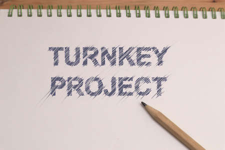 Turnkey project, text words typography written on book against wooden background, life and business...