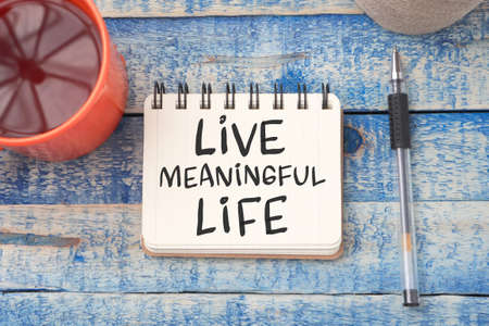 Live Meaningful Life, text words typography written on book against wooden background, life and...