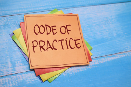 Code of practice, text words typography written on paper against wooden background, life and business motivational inspirational conceptの写真素材