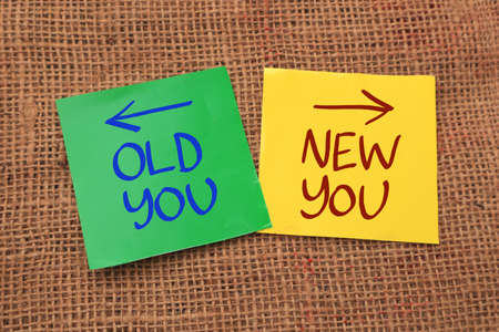Old you new you, text words typography written on paper against wooden background, life and business motivational inspirational conceptの写真素材