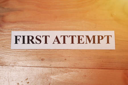 First attempt, text words typography written on paper against wooden background, life and business motivational inspirational conceptの写真素材
