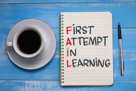 Fail first attempt in learning, text words typography written on paper against wooden background, life and business motivational inspirational conceptの写真素材