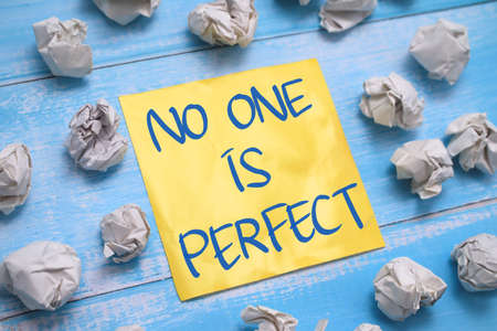 No one is perfect, text words typography written on paper against wooden background, life and business motivational inspirational conceptの写真素材