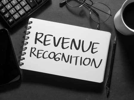 Revenue Recognition, text words typography written on book against dark background, life and business motivational inspirational conceptの写真素材