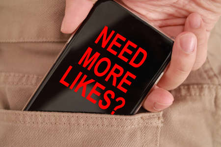Need more likes question, text words typography written on smart phone, life and business social media follower motivational inspirational conceptの写真素材