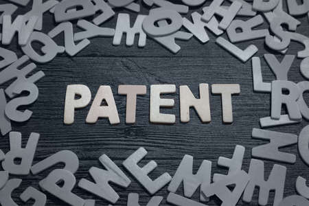 Patent, text words typography written with wooden letter on black background, life and business motivational inspirational conceptの写真素材