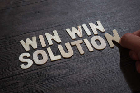 Win win Solution, text words typography written with wooden lettering on dark background, life and business motivational inspirational conceptの写真素材