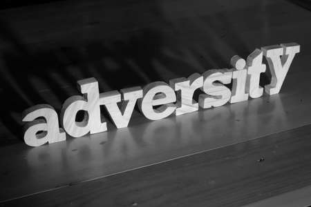 Adversity, text words typography written with wooden letter on black background, life and business negativity conceptの写真素材