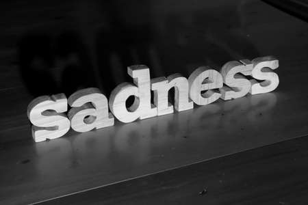 Sadness, text words typography written with wooden letter on black background, life and business negativity conceptの写真素材