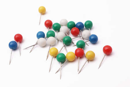 Colorful push pin thumbtack paper clip office business supplies isolated on whiteの写真素材