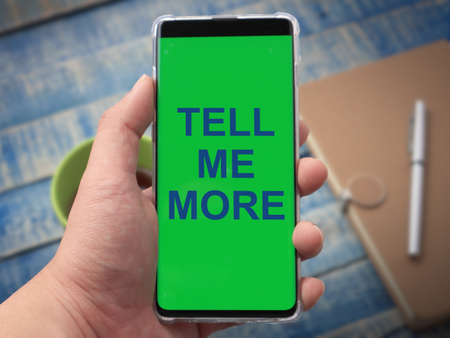Tell Me More, text words typography written on phone, success  life and business motivational inspirational conceptの写真素材