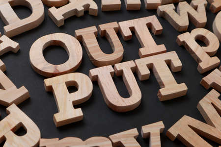 Output, text words typography written with wooden letter on black background, life and business motivational inspirational conceptの写真素材