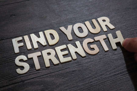 Find your strength, text words typography written with wooden letter on black background, life and business motivational inspirational conceptの写真素材