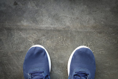 Top view of running shoe on asphalt track, athlete or a person ready to run, jogging workout conceptの写真素材
