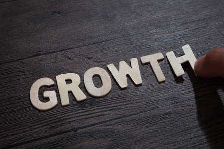 Growth, text words typography written with wooden letter on black background, life and business motivational inspirational conceptの写真素材