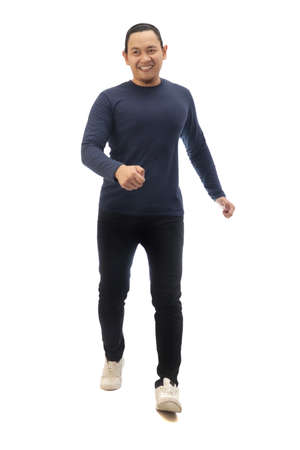Man wearing casual grey shirt black denim and white shoes, walking forward, moving with confidence. Full body portrait isolated cut outの写真素材