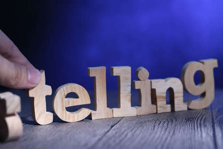 Selling to telling, soft sell strategy by story telling concept, text words typography written with wooden letter on blue background, business motivational inspirational conceptの写真素材
