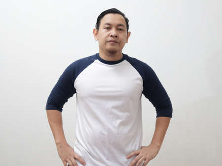Asian man looking at camera with upset annoyed disappointed gesture over white backgroundの写真素材