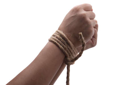 Person hands tied with rope isolated on white background, captive victim restrained conceptの写真素材