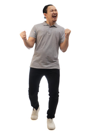 Asian man wearing grey shirt black denim and white shoes, screaming shouting celebrating victory, winning gesture. Full body portrait isolated cut outの写真素材
