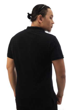 Rear view of Asian man with bun hair wearing black shirt isolated cut out on white, looking to the sideの写真素材