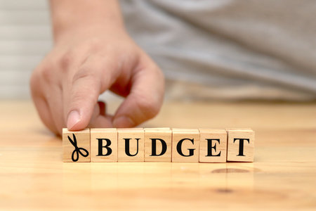 Saving on budget, text words typography written with wooden letter with scissor icon, life and business motivational inspirational conceptの写真素材