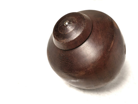 Wooden gasing, asian traditional game toy, spinning top originally comes from Indonesia or Malaysia over white backgroundの写真素材