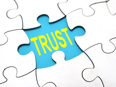 Trust, text words typography written under jigsaw puzzle, life and business motivational inspirational conceptの写真素材