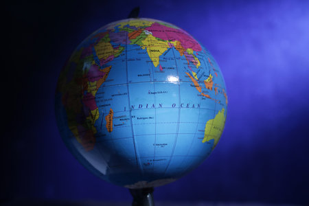 Tenggarong, Indonesia, June 29th 2021. Photo image of an earth globe on dark blue background with light raysの写真素材