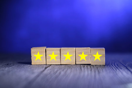 Five stars on wooden block, top quality rating of service or product concept