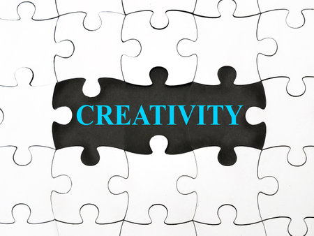 Creativity, text words typography written under jigsaw puzzle, life and business motivational inspirational terms conceptの写真素材