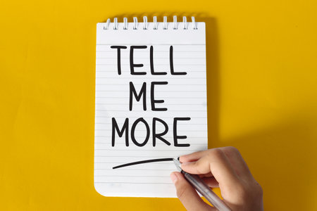 Tell me more, text words typography written on paper, life and business motivational inspirational conceptの写真素材