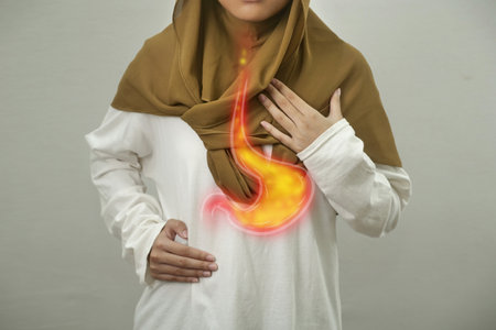 Digital composition of internal digestive system with stomach acid flows back to esophagus on person with GERD disease, woman with suffer from heartburn pain in her chest, health and medical conceptの写真素材