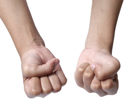 LIttle girls hand doing punching fist gesture, cut out isolated on whiteの写真素材