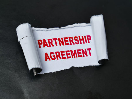Partnership agreement, word text written on ripped paper, business terms conceptの写真素材